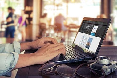 man working on laptop in bar