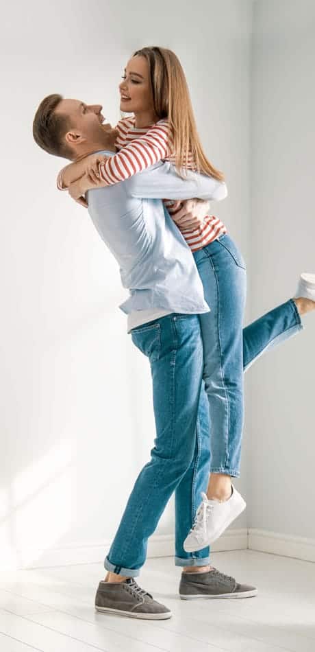 man lifting women off her feet hugging